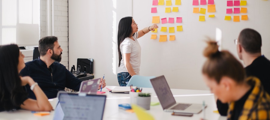 B2B marketing strategy meeting with team analyzing analytics dashboards and pipeline data